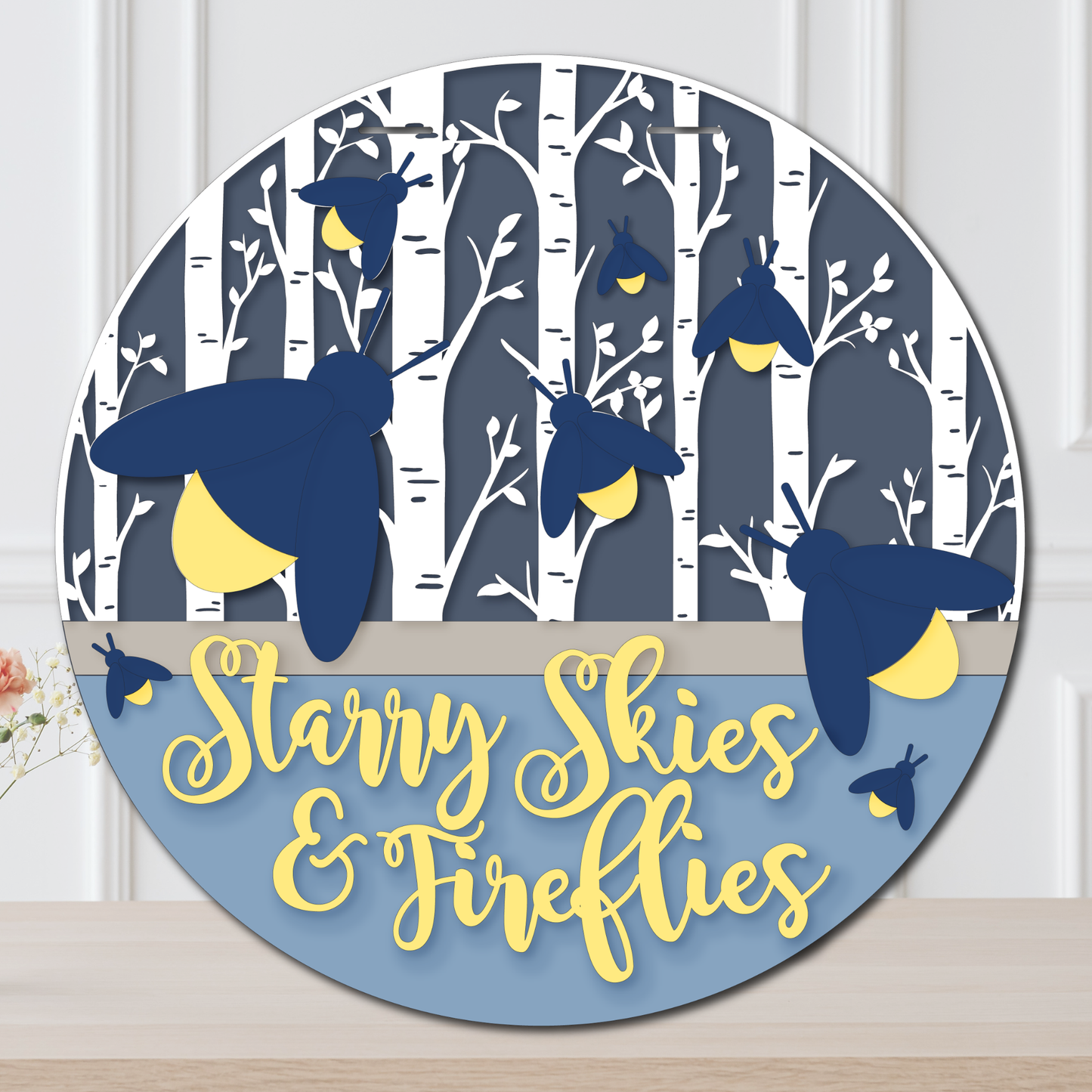 Decorative wall art with fireflies and 'Starry Skies & Fireflies' text on a blue background.