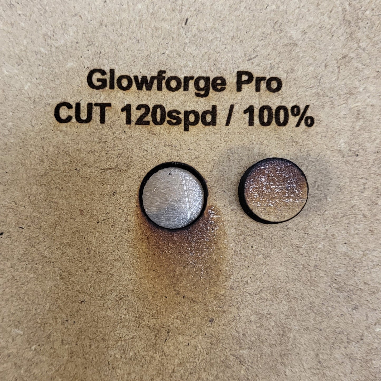 Two cut pieces of material of MDF with 'Glowforge Pro CUT 120spd / 100%' text.