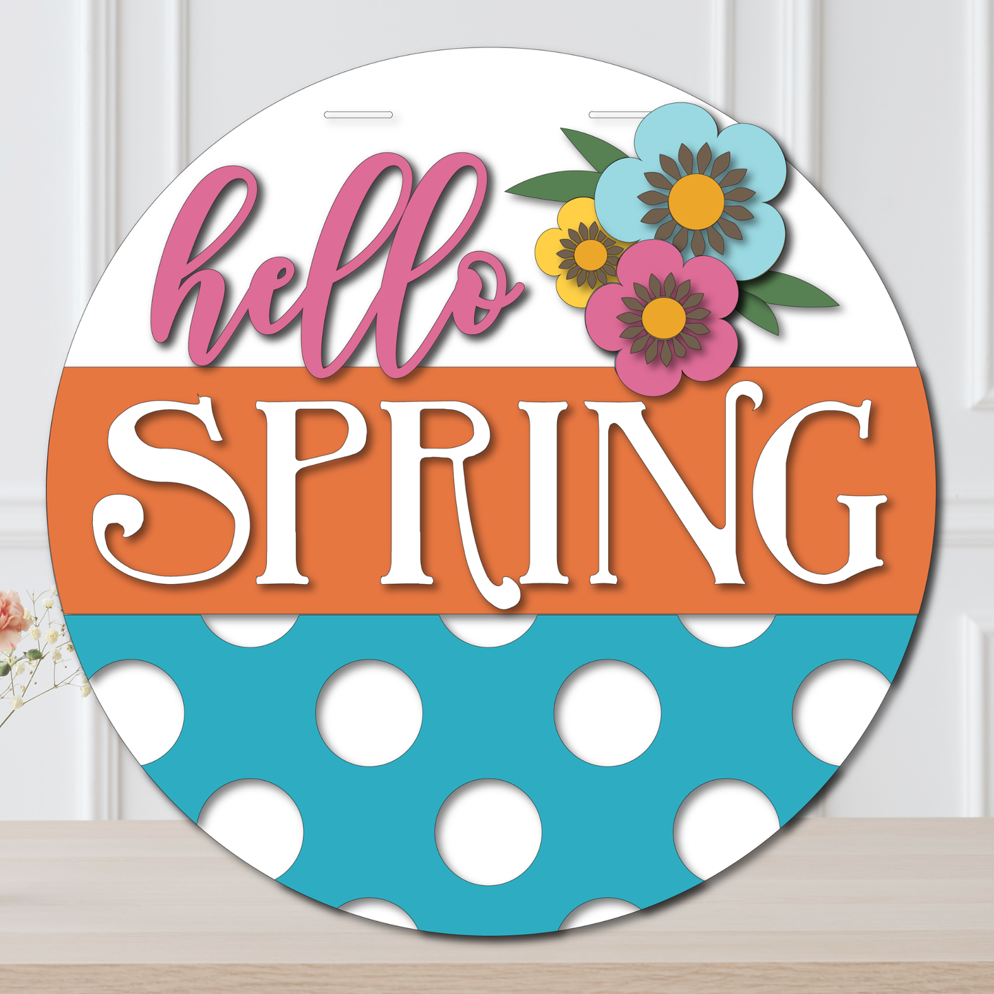 Decorative sign with 'hello SPRING' text and floral elements on a white background