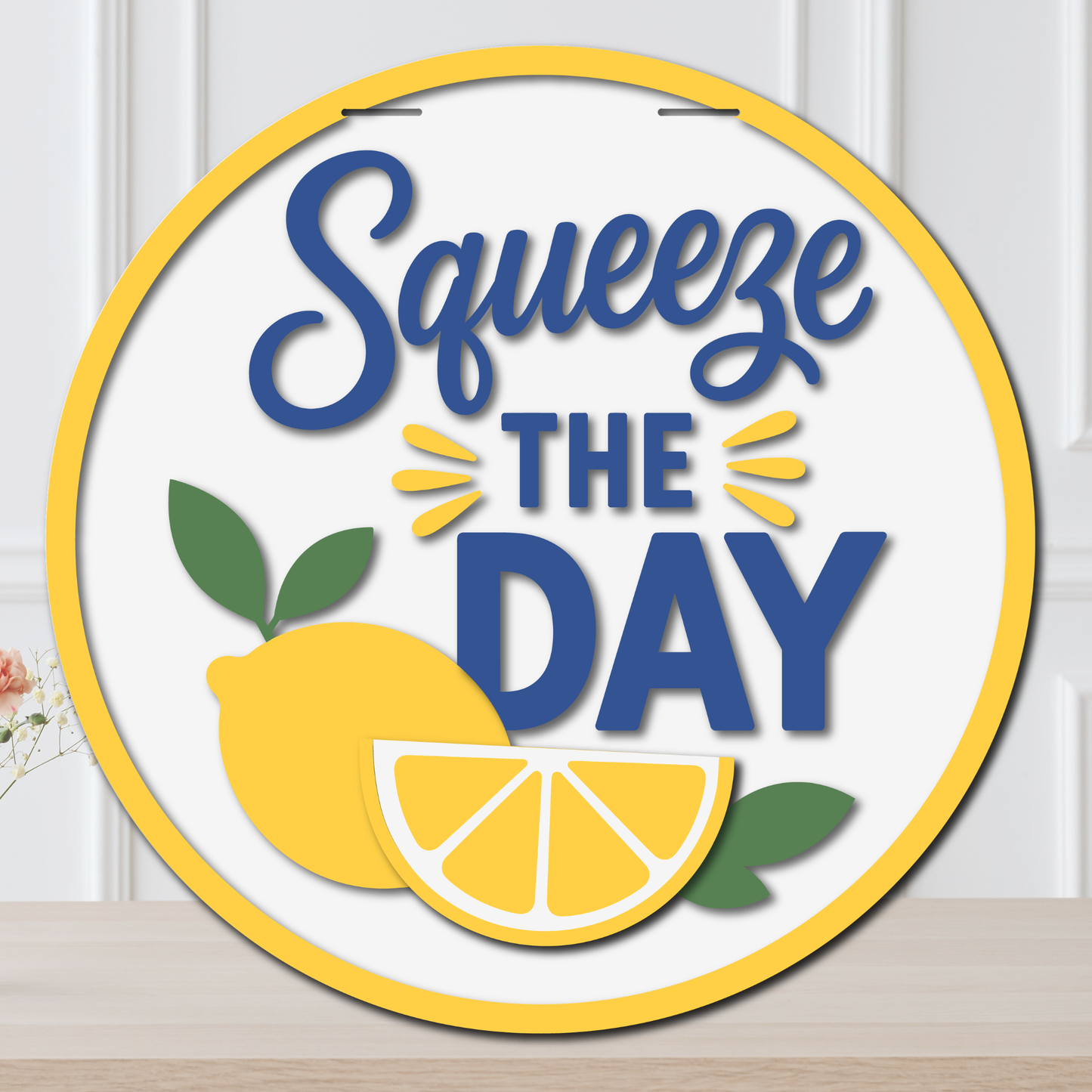 Circular sign with 'Squeeze the Day' text and lemons on a white background