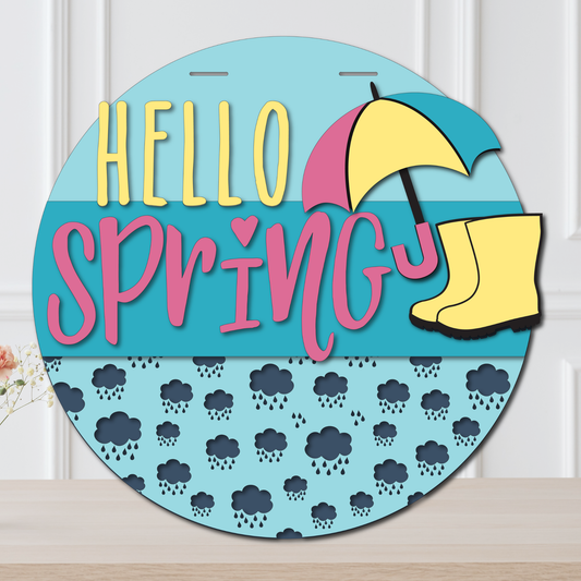 Decorative sign with 'Hello Spring' text, umbrella, and rain boot on a blue background.