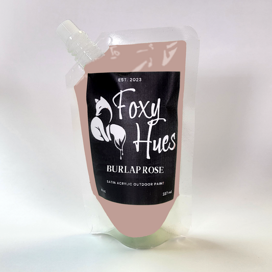 Paint container with 'Foxy Hues' label on a white background