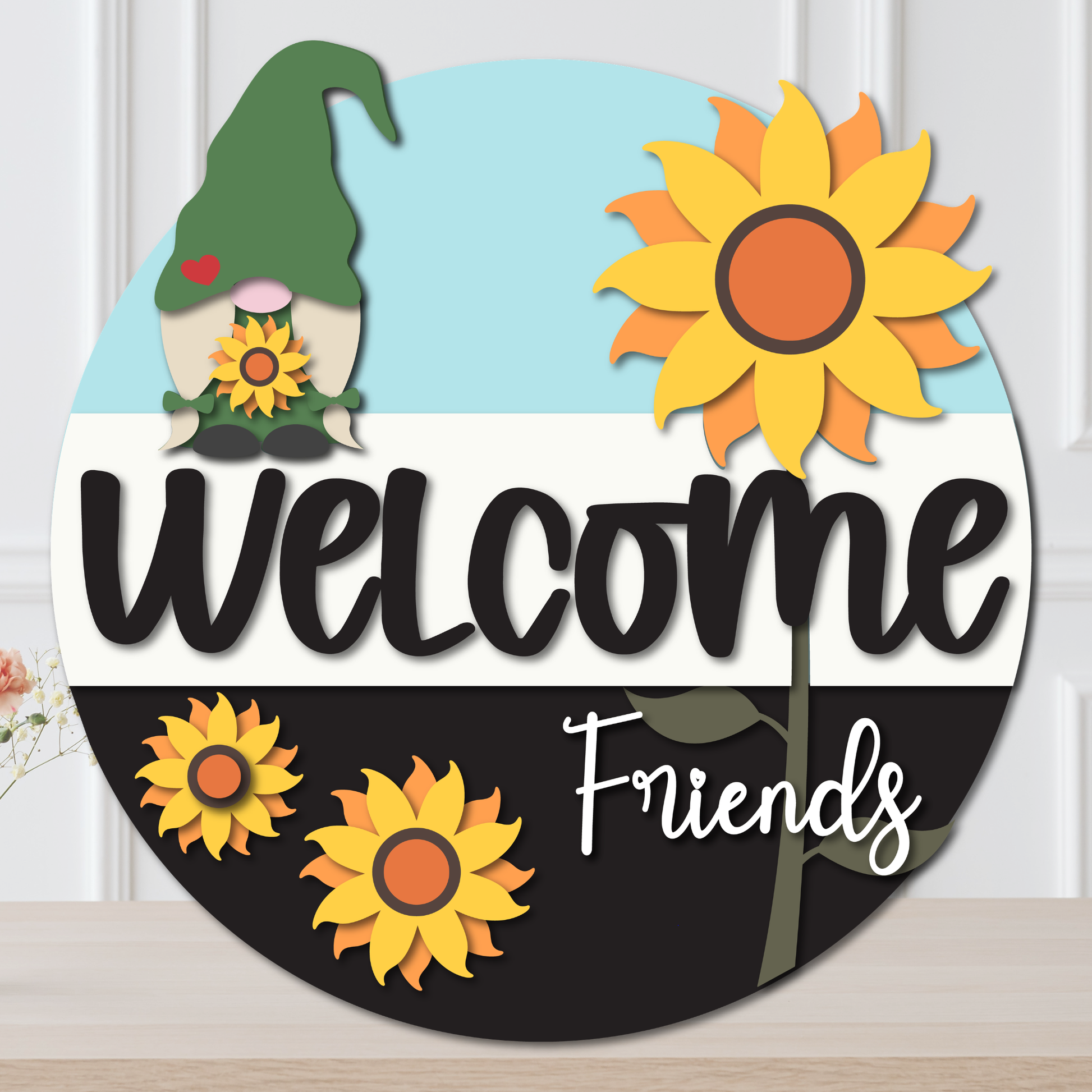Decorative sign with a gnome, sunflowers, and 'Welcome Friends' text on a white background.