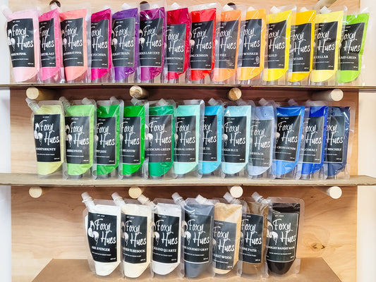 Shelf displaying various colors of Foxy Hues hair dye packaging.