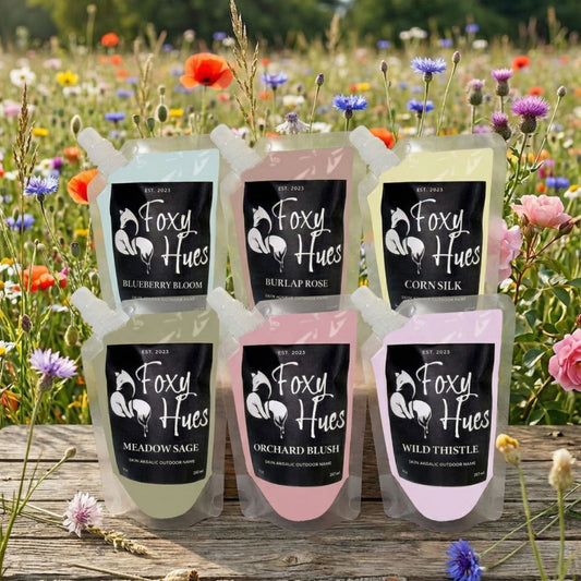 Foxy Hues product packaging in a field of flowers